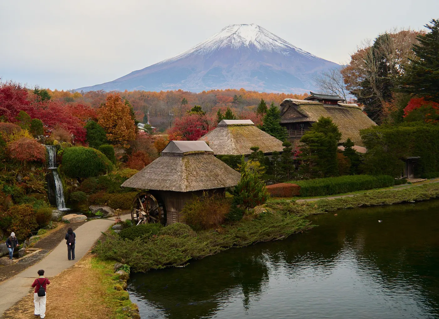 Thatched houses and clear ponds at Oshino Hakkai with Mt Fuji behind